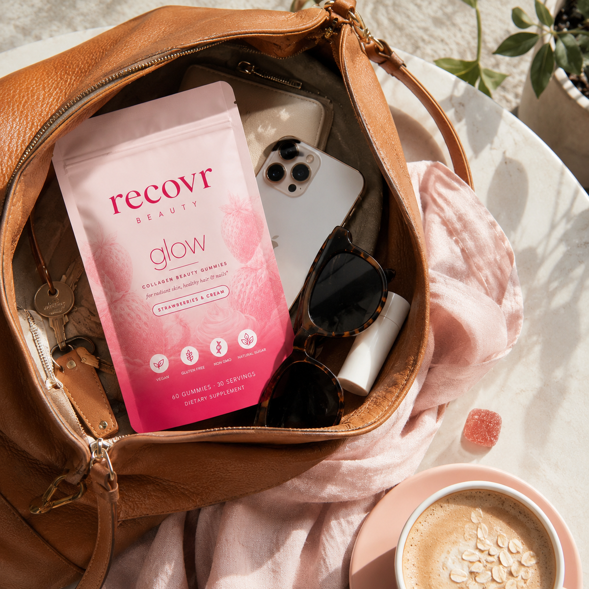 recovr glow pouch in a handbag with phone, keys and sunglasses, travel-friendly